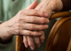 Shutterstock: hands resting on armrest.