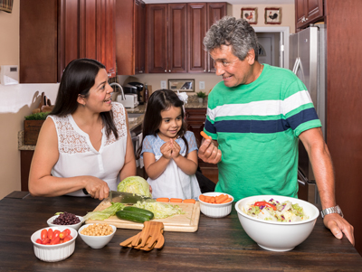 A multigenerational family making dinner