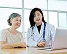 An elder lady talking with a woman doctor